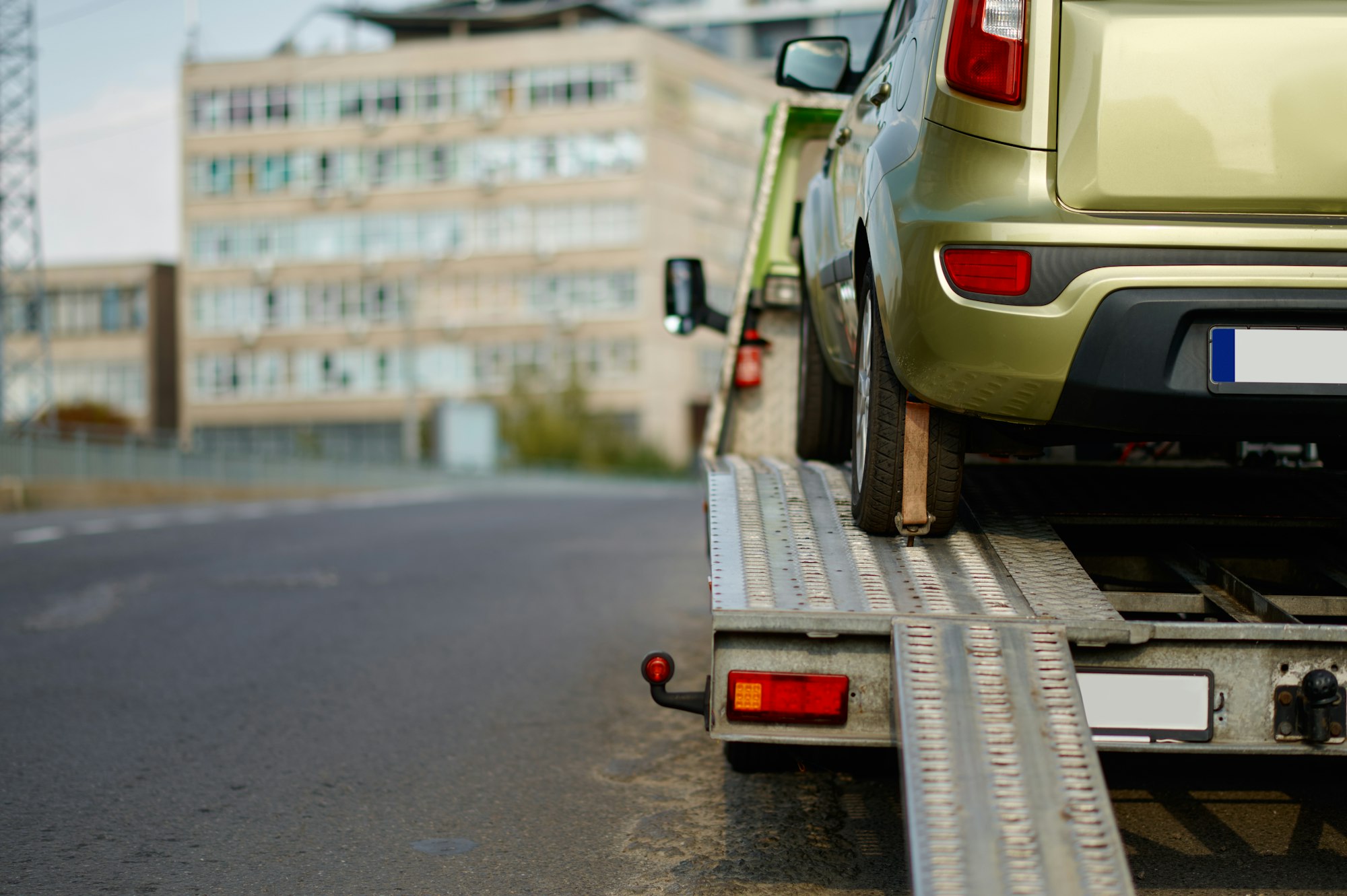 How Much Does It Cost To Tow A Car? Broken car standing on flatbed tow truck