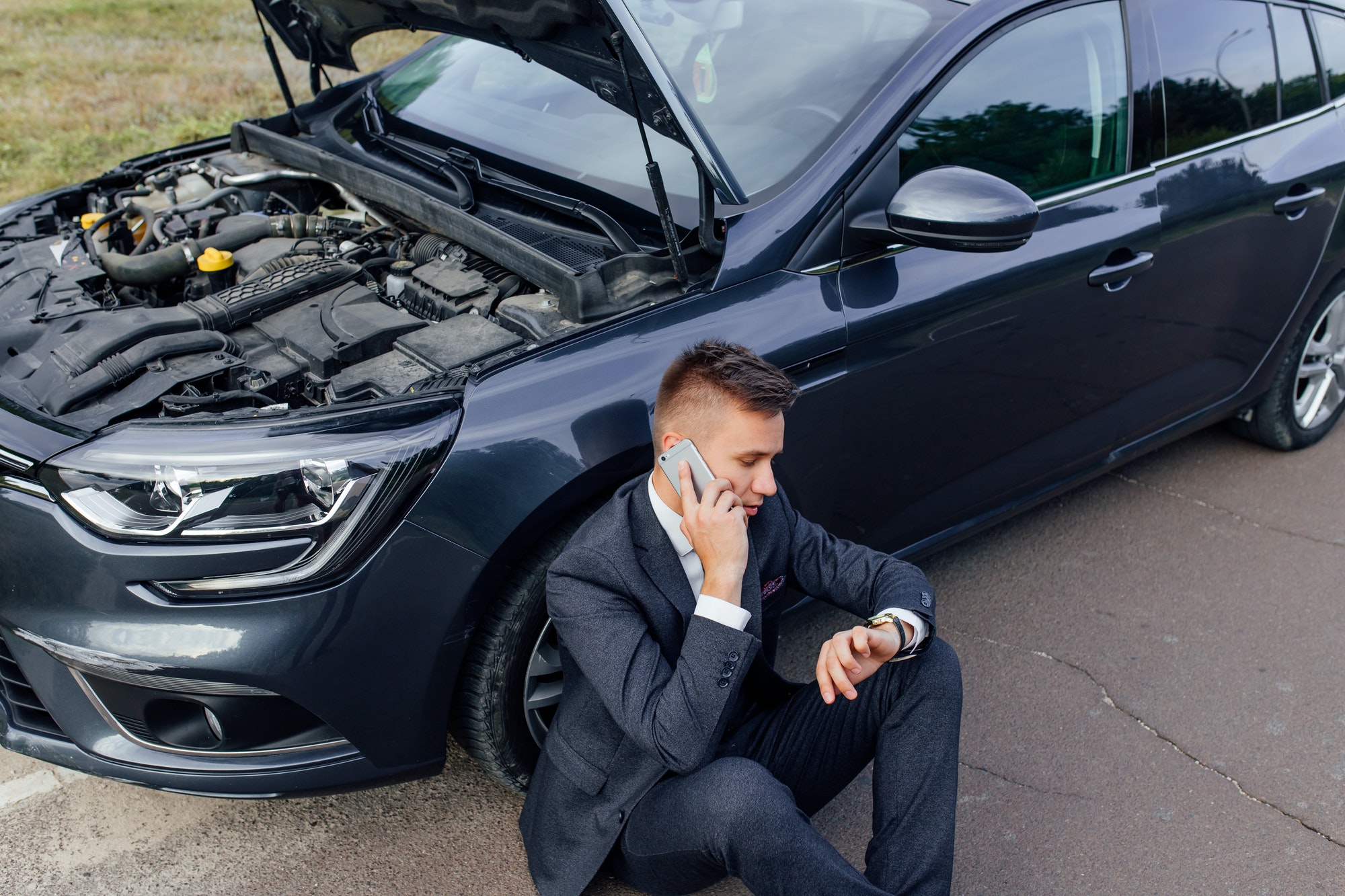 Why Might You Need Roadside Assistance Jump Start? Navigating Roadside Challenges: A Comprehensive Guide to Discount Auto Assistance and Towing in St. Paul, MN Businessman Calling for Roadside Assistance.