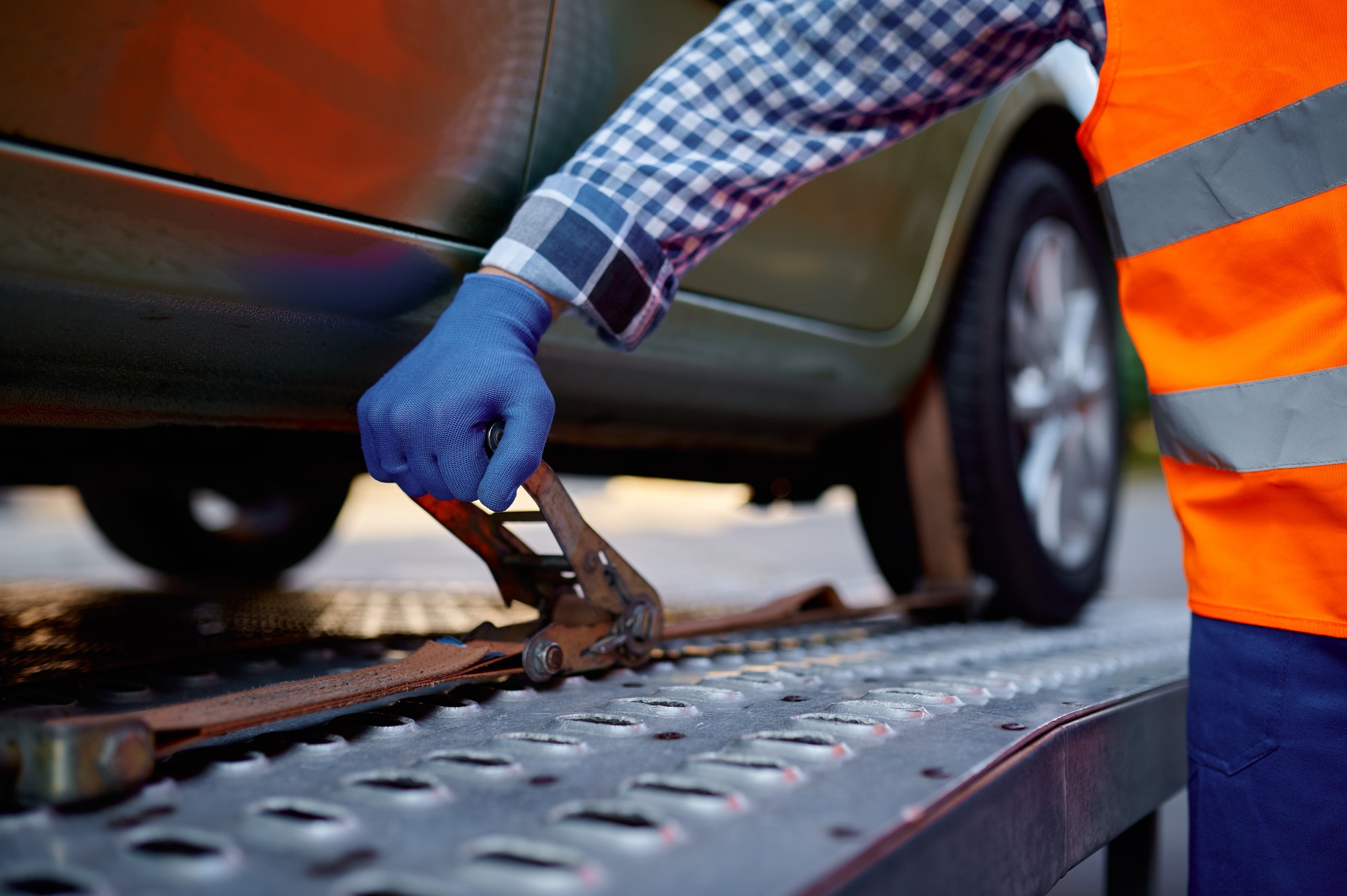 Revive Your Drive: Jumpstart Assistance in Minneapolis Closeup tow truck driver hand fixing car