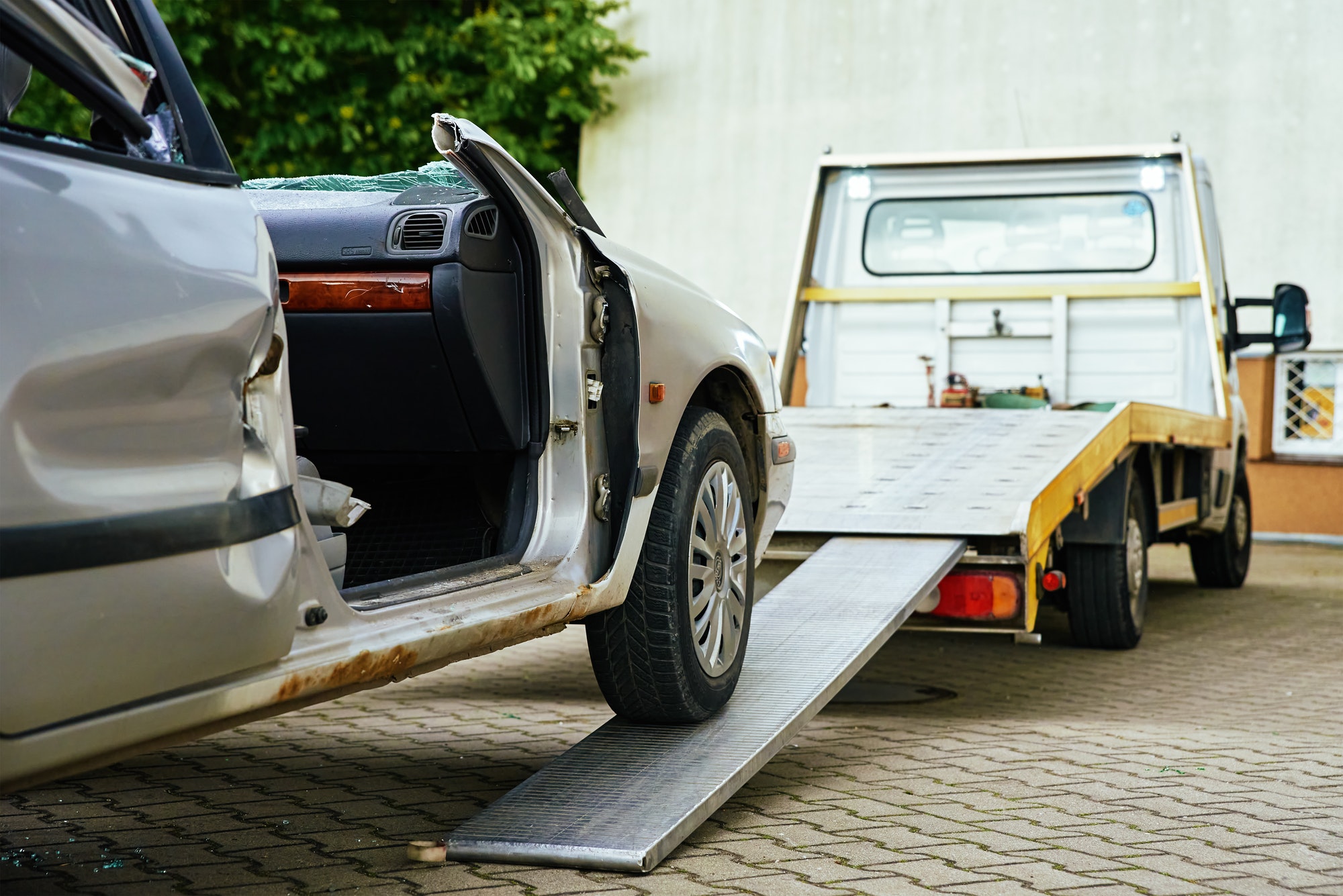 Swift Solutions: Tow Truck Service in Maplewood for Unparalleled Roadside Rescues Crashed car loading into tow truck after traffic accident on road