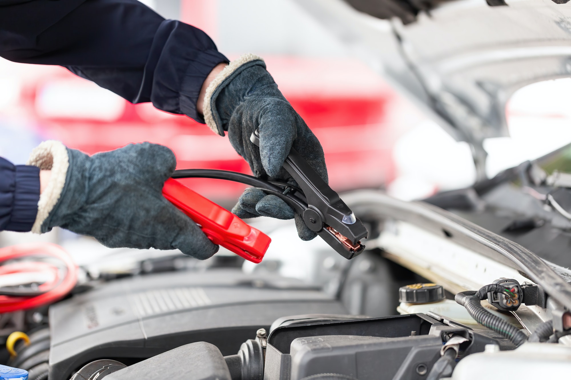 Car Wont Start With Jump? Different Methods Of Towing Human trying to start engine with jumper cables in close up