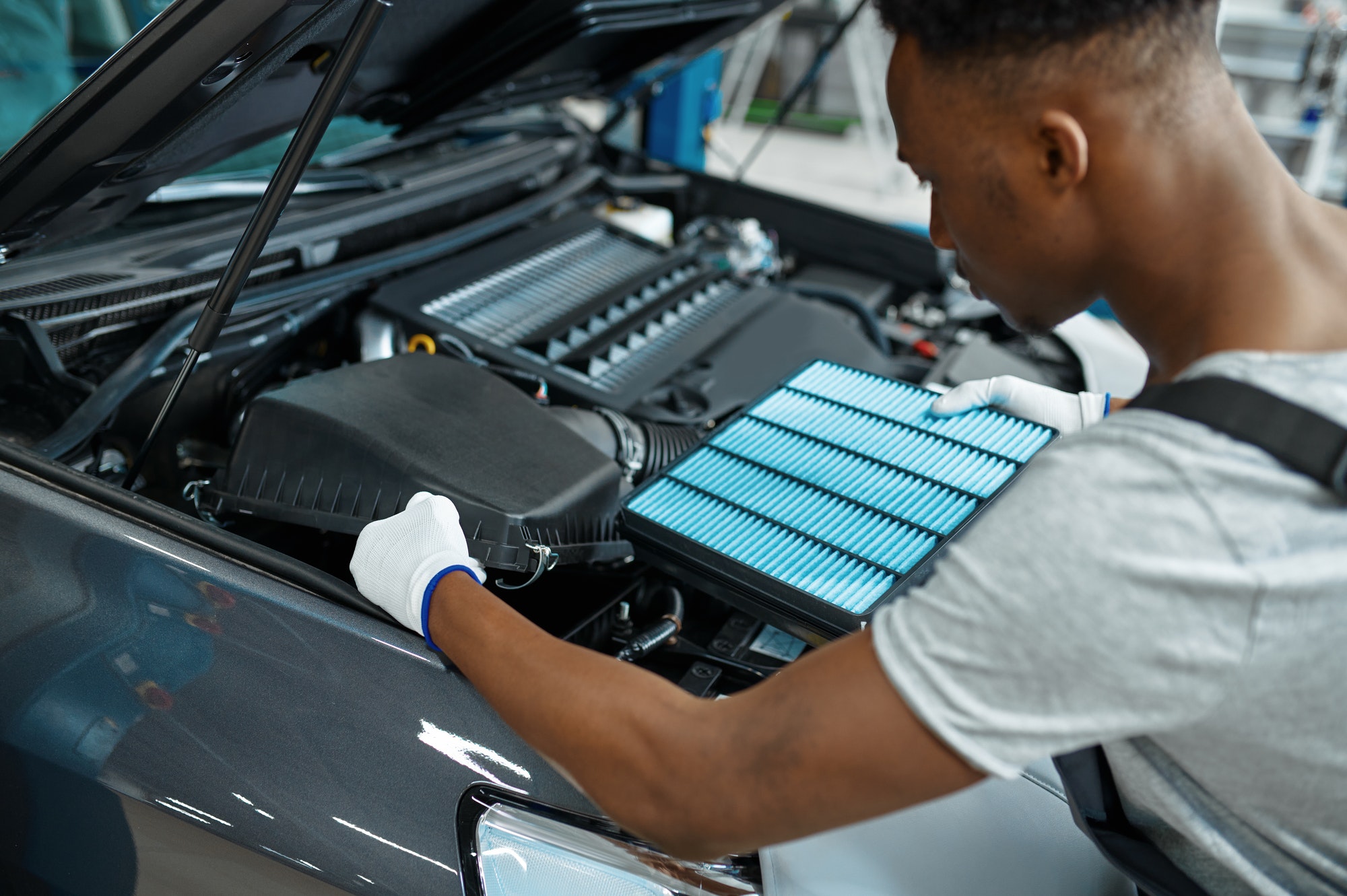 How Often to Change Air Filter in Car Male mechanic changes air filter, car service