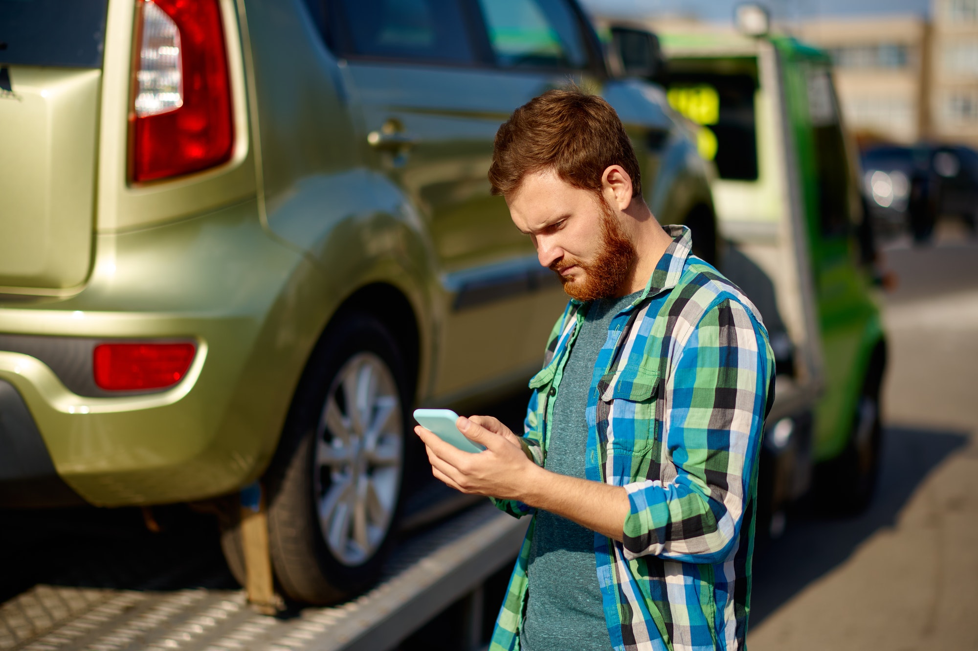 Navigating Roadside Challenges: Discount Auto Towing - Your Premier Roseville Towing Partner Man calling while tow truck picking up car