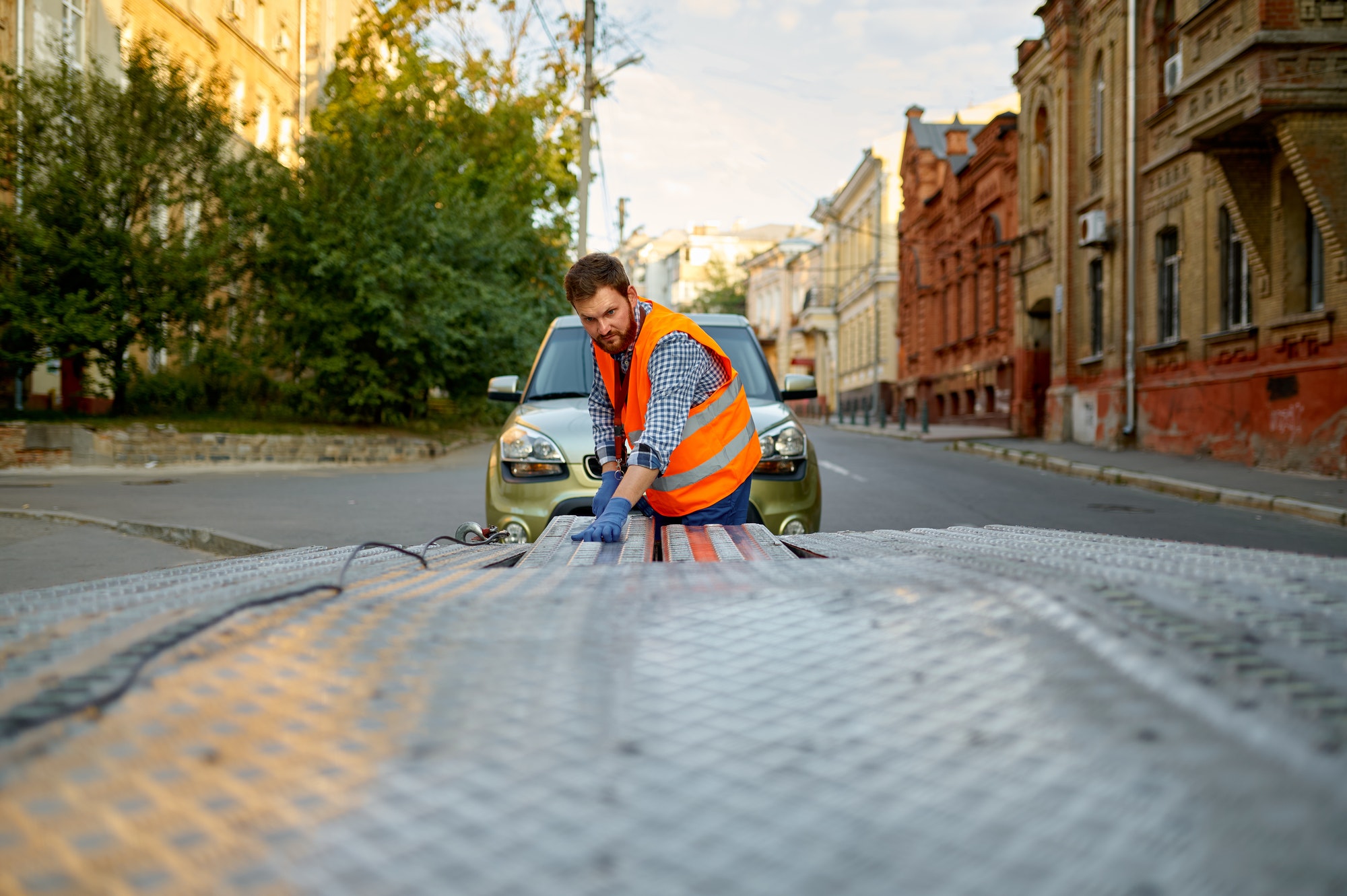 Discount Auto Towing: Your Reliable 'Towing Company Near Me' Partner in Minneapolis and St. Paul Man preparing towing truck for car loading