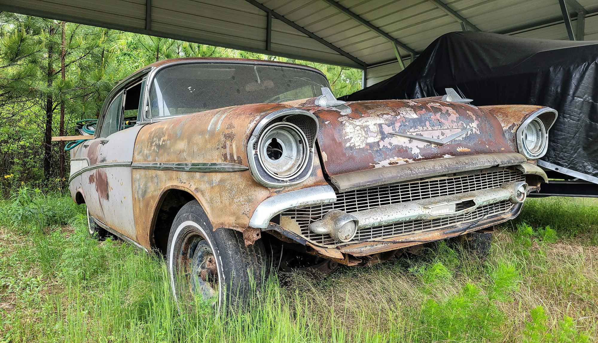 Junk Cars No Title or Registration Old rusted car in junk yard hoping to salvage some parts.