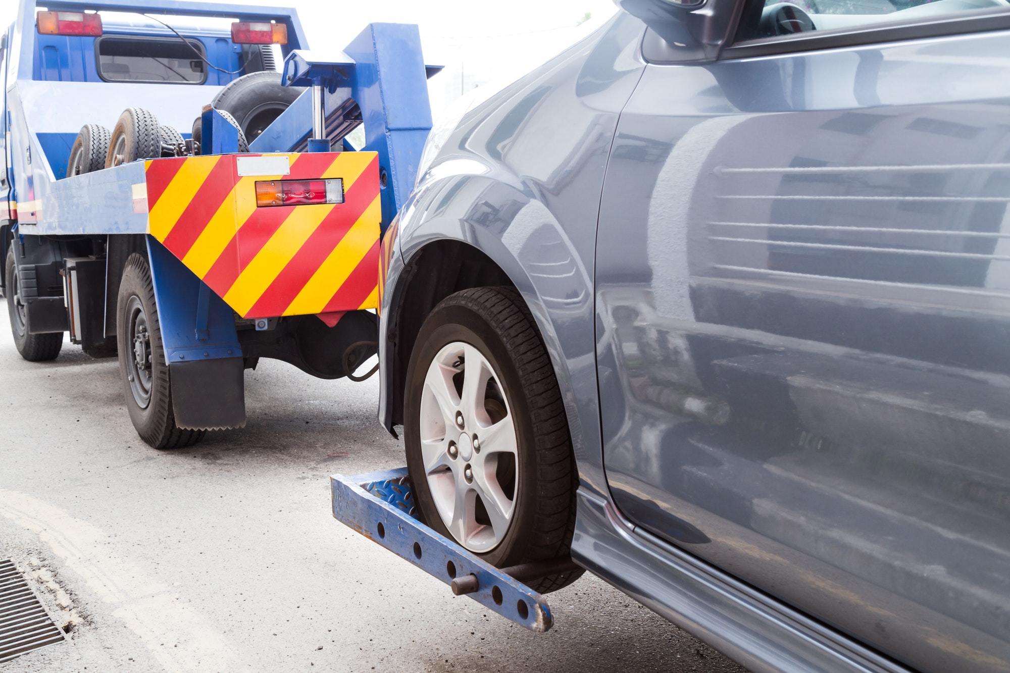 How To Get A Towed Car Back Without Paying? Tow truck towing a broken down car on the street