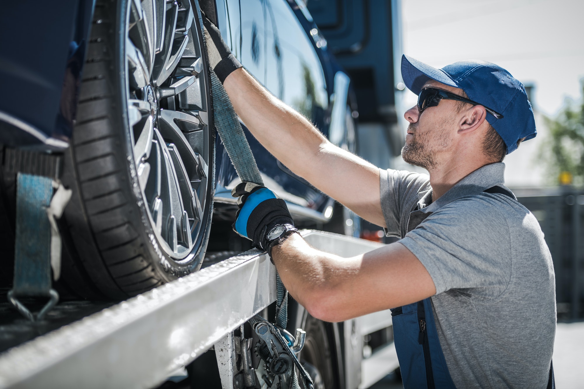 More About 24-Hour Roadside Assistance Towing Truck Driver Securing Transported Vehicle