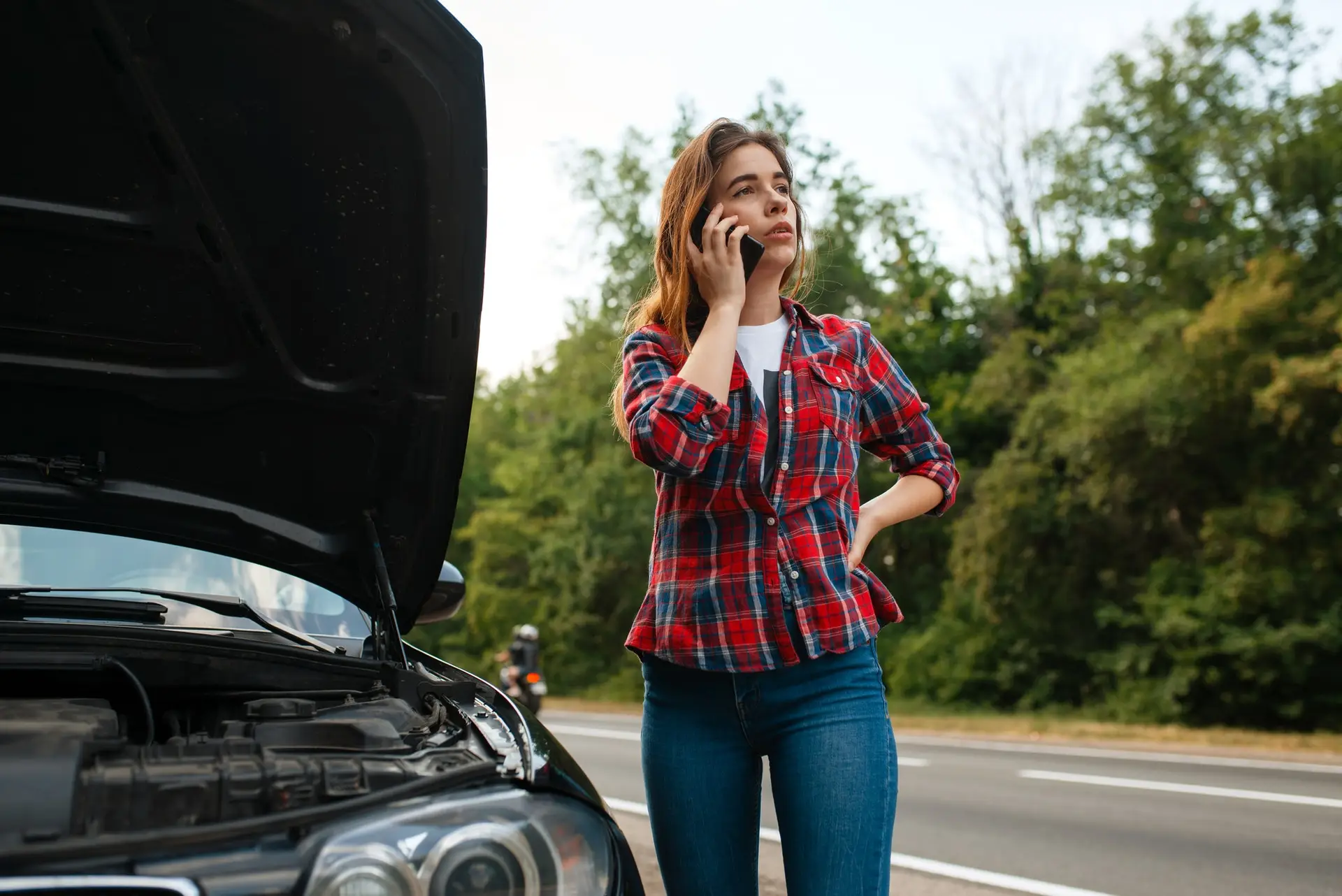 Can You Flat Tow Any Vehicle? Flat Towing Vehicle List and Why Flat Towing Is Great for Travellers Woman calling a tow truck on road, car breakdown