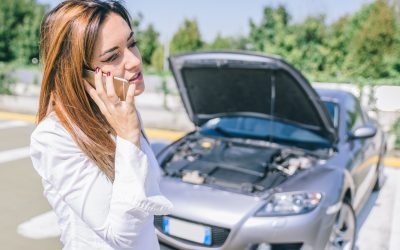 Car breakdown. young woman calling assistance on the phone auto towing