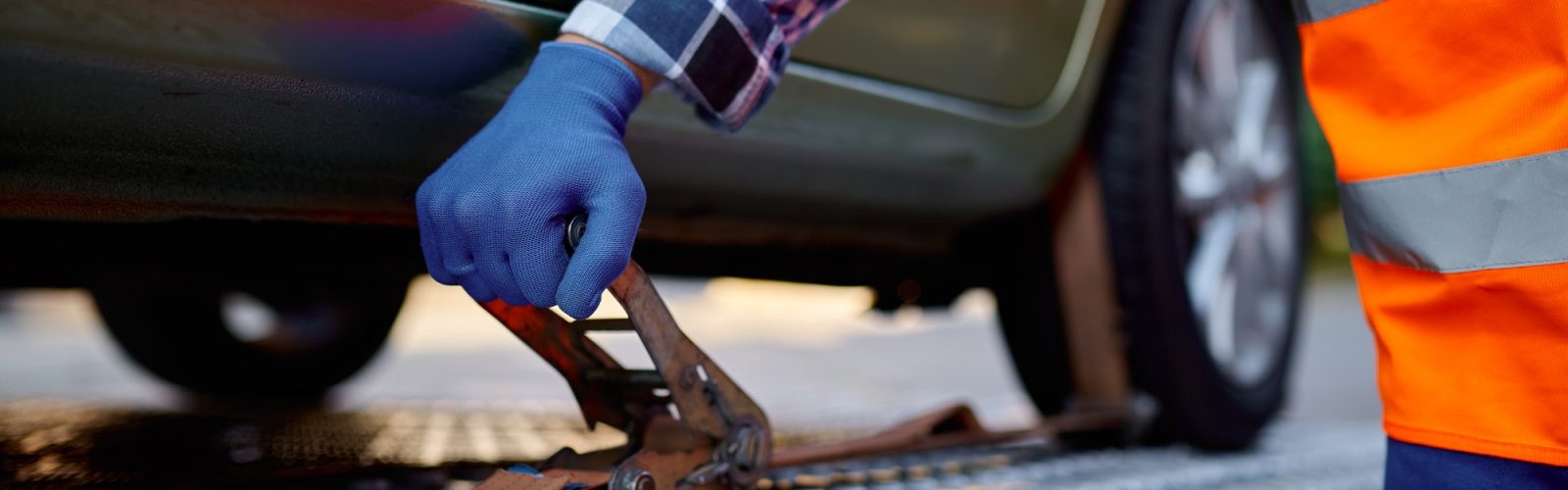 Revive Your Drive: Jumpstart Assistance in Minneapolis Closeup tow truck driver hand fixing car