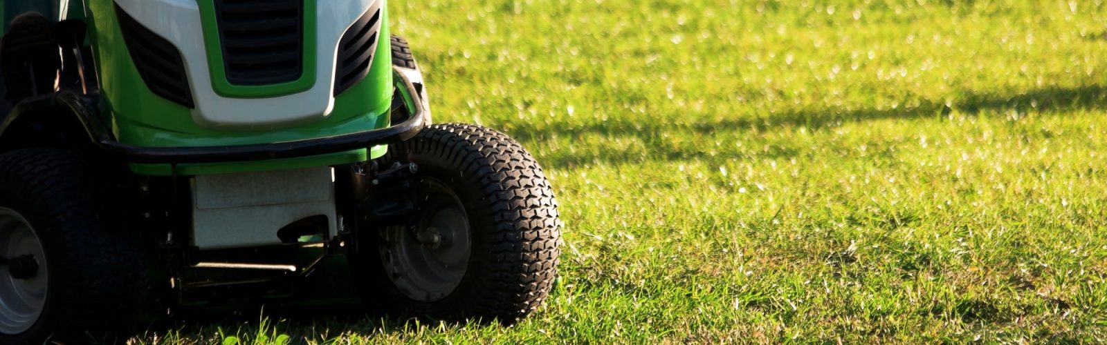 Basics to Owning a Lawn Tractor: When and How to Change a Lawn Tractor Tire Green lawn mower tractor.