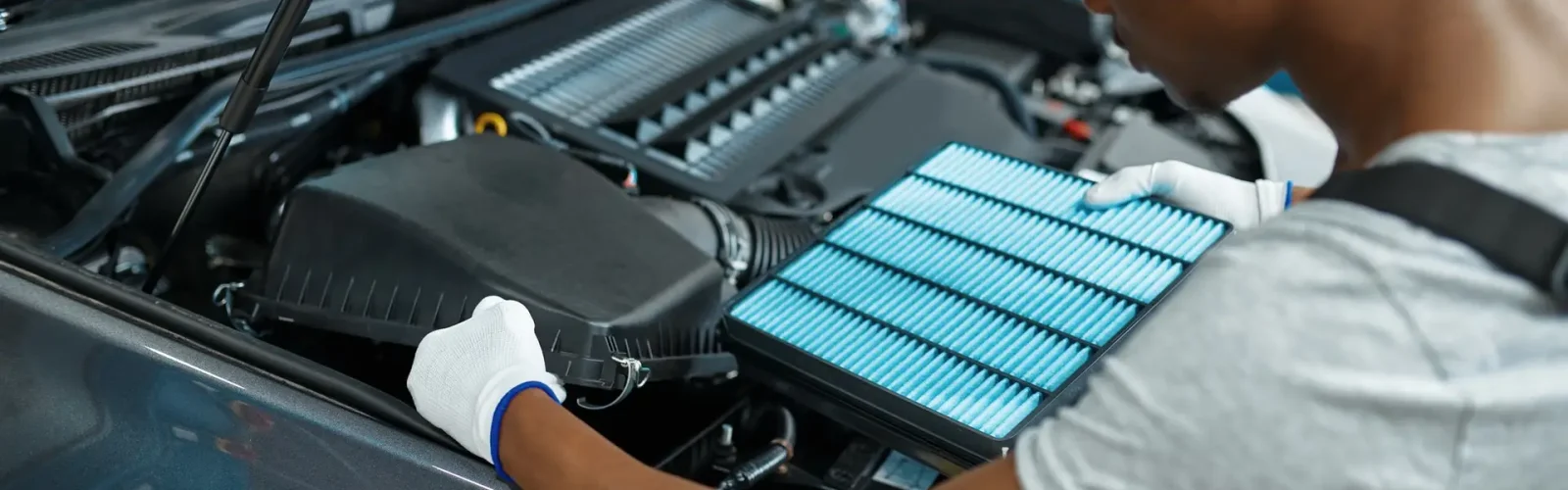 How Often to Change Air Filter in Car Male mechanic changes air filter, car service