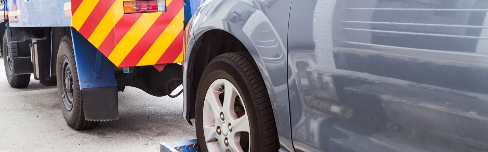 How To Get A Towed Car Back Without Paying? Tow truck towing a broken down car on the street