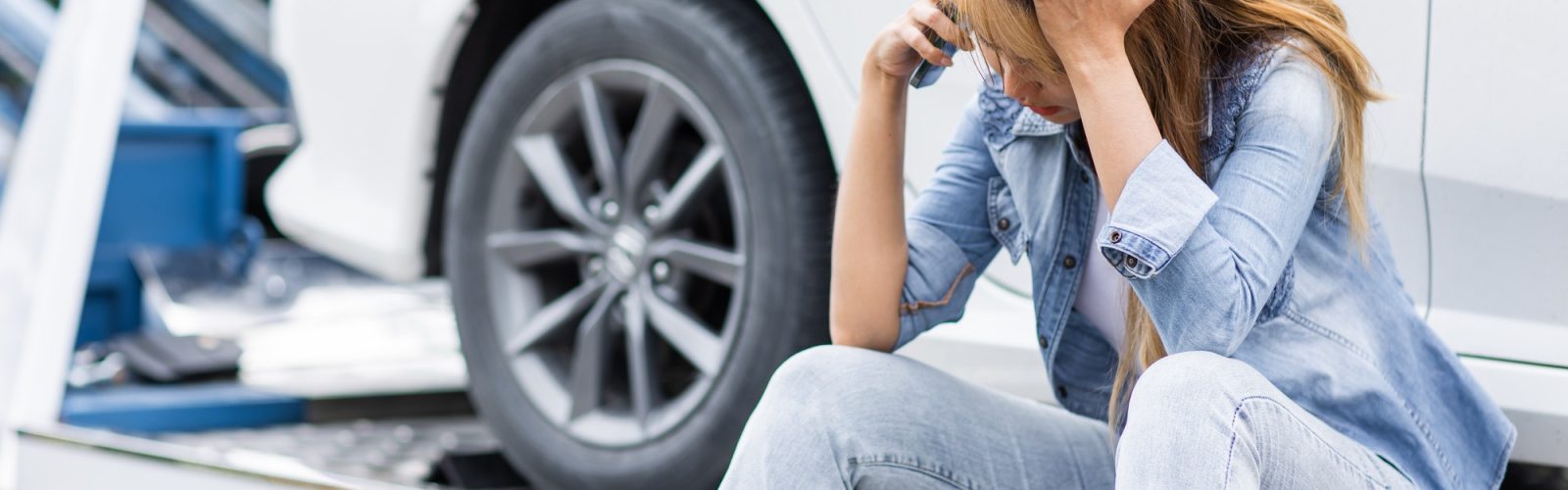 Do Towed Vehicle Locators Work? woman calling roadside car broken for need help while towing service assistance moving her car out